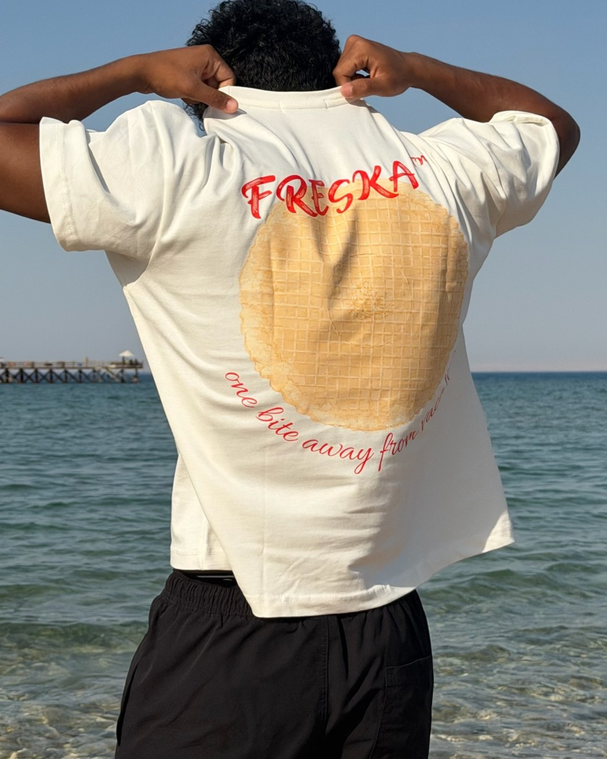 Freska oversized tee by Meilo in white — waffle ice cream back print, worn by the sea, Egyptian streetwear